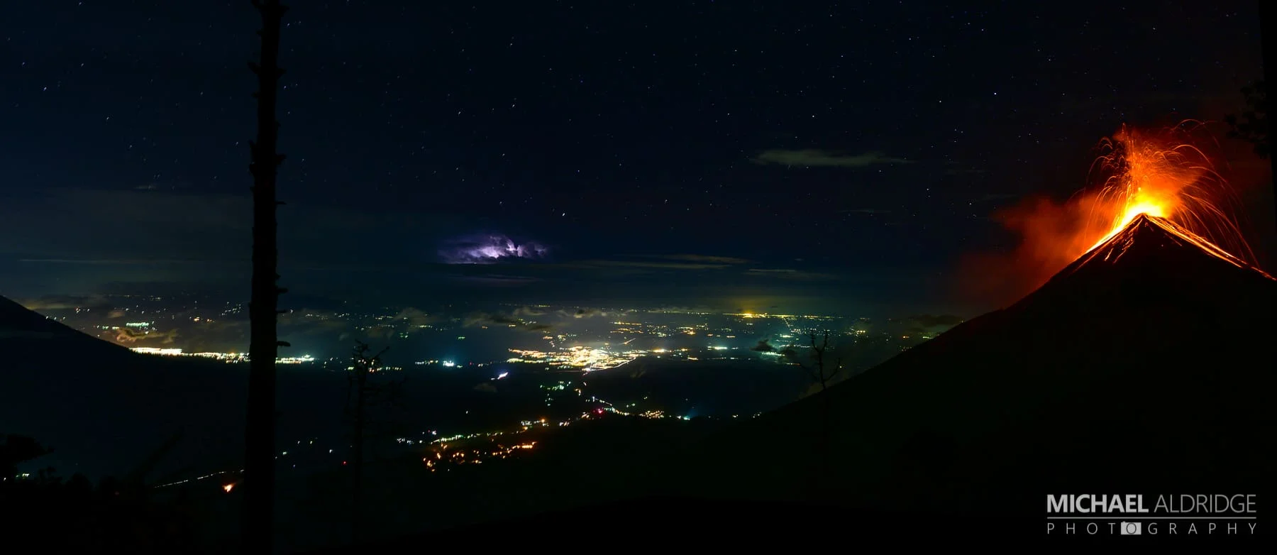Volcán de Fuego eruption with lightening storm below