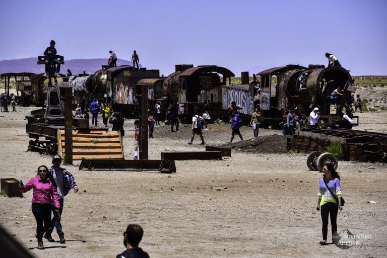 Tourists in Train Graveyard in Uyuni, Bolivia